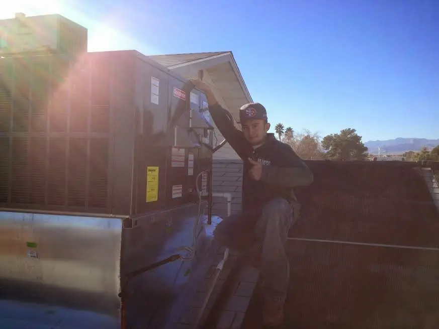 HVAC technician performing Air Duct Repair on a rooftop unit in North Fair Oaks